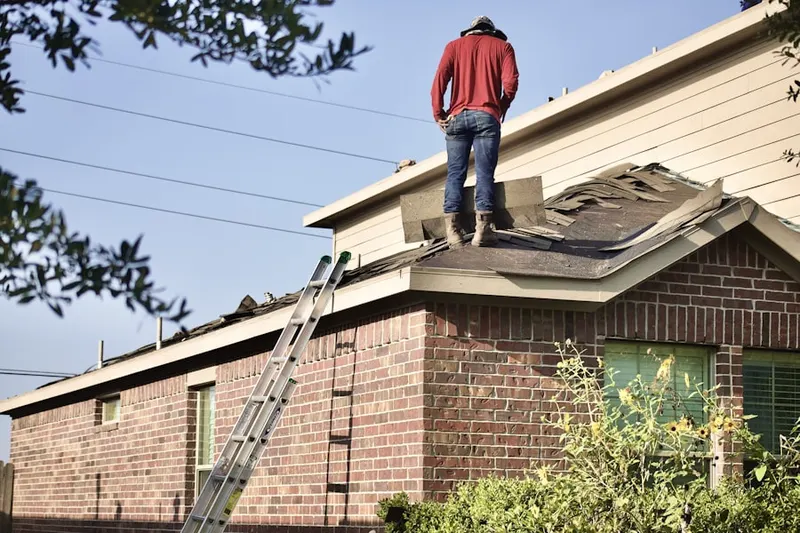 Professional roofer working on a residential roof in Lower
